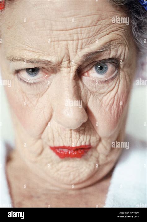 Elderly woman raising eyebrow and looking at camera, portrait, close-up Stock Photo - Alamy