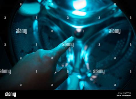 A Hand Inside Washer Pointing A Finger In A Blue Light Future Sci Fi