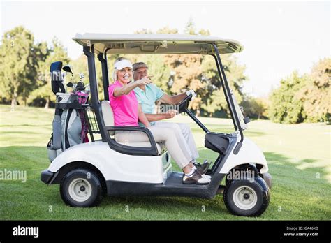 Mature Woman Pointing While Sitting In Golf Buggy Stock Photo Alamy