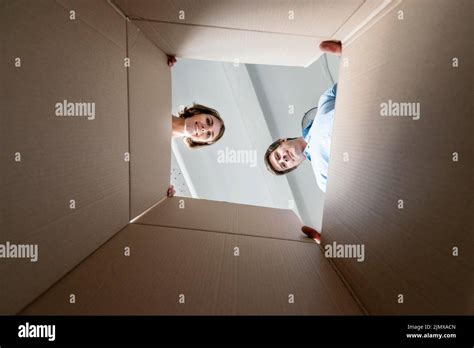 Couple Looking Inside Empty Box While Packing Move Stock Photo Alamy
