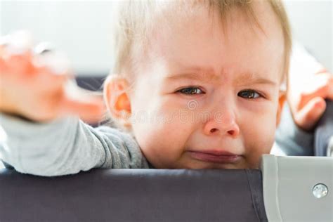 Portrait Of One Year Old Baby Girl Crying And Reaching Hand Towards