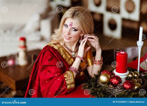 Beautiful And Sensual Blonde Girl In Indian Red Saree Sitting At Stock Image Image Of Hindu