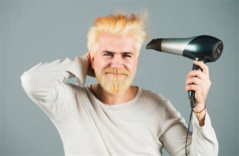Blonde Bearded Man Hair Dry Handsome Man With Long Hair Dries His Hair With A Hairdryer Stock