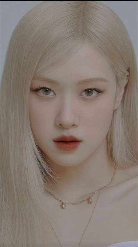 A Woman With Long Blonde Hair Wearing A Necklace