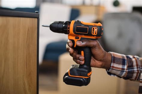 Premium Photo Close Up Of Man Assembling Furniture Using Electric Drill