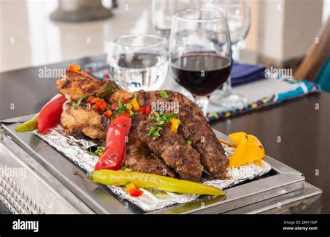 Mixed grill meat a la carte meal with on hot plate at restaurant table setting Stock Photo - Alamy