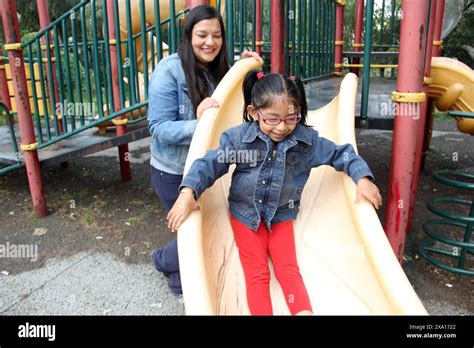 Divorced Single Mom And Brunette Latina 4 Year Old Daughter Play In The Park Games In Poverty