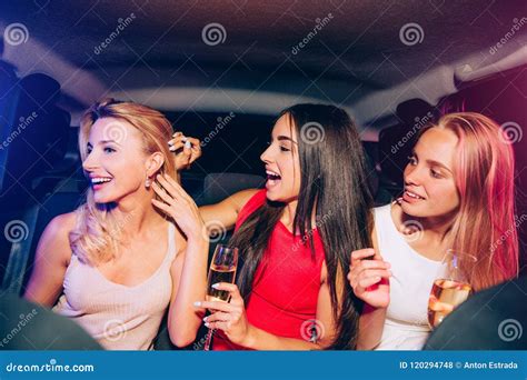 Excited Girls Are Looking At Their Friend Brunette Is Touching The Ear Of Her Blonde Firend