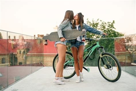 Premium Photo One Trendy S Girl With Bike Waiting For Her Hot Female Friend In Tempting