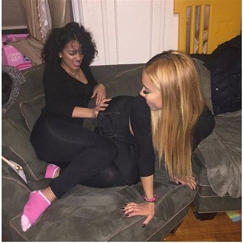 Two Women Sitting On A Couch Talking To Each Other