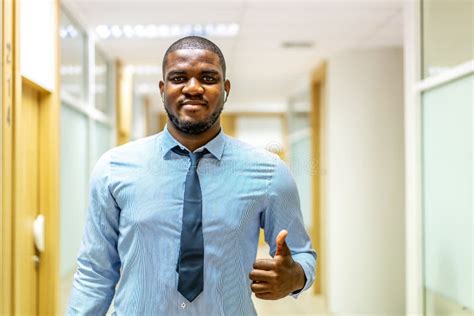 Portrait Of Smiling Mature African American Executive Businessman In Suit Looking At Camera