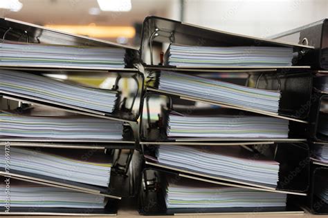 files stacked  filing cabinet  large pile  binders filled