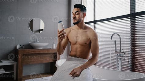 Arab Indian Guy Muscular Naked Sexy Unshaven Man Wears White Bath Towel On Hips Sits In Bathroom