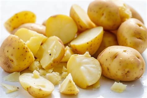 Premium Photo Fresh Potatoes With Peel On A White Background Closeup