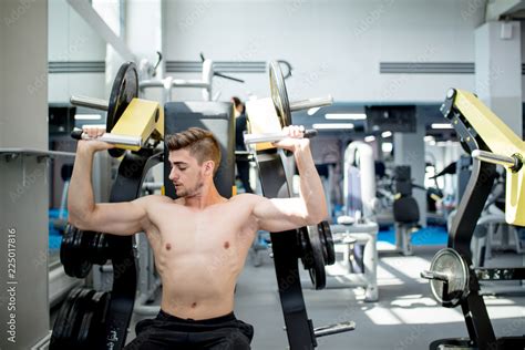 Handsome Crossfit Instructor With Naked Torso Trains Abdominal Musculs Using Gym Apparatus