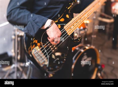 Concert View Of Musician Electric Bass Guitar Player With During Band