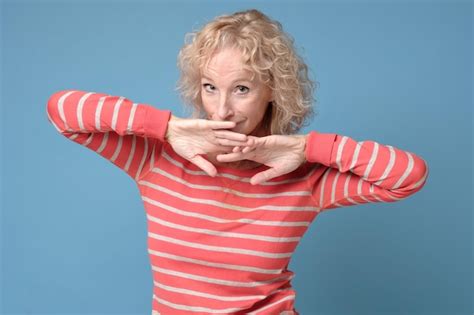 Premium Photo Shy Blonde Woman Smiling With Hands In Face