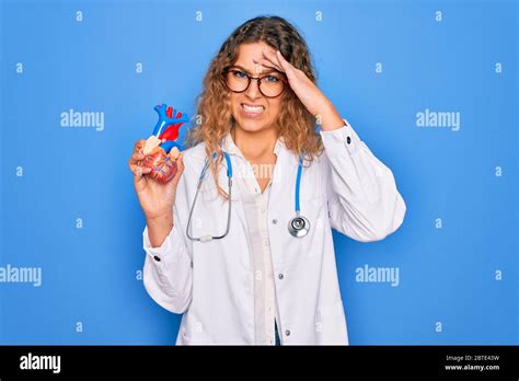 Junge Sch Ne Blonde Rztin Mit Blauen Augen Tr Gt Stethoskop Herz Mit Hand Auf Den Kopf
