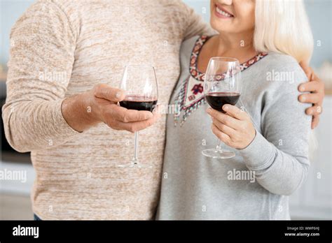 Happy Mature Couple Drinking Wine In Kitchen Stock Photo Alamy