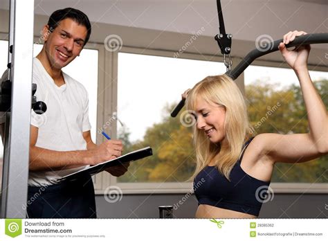 Attractive Blonde Woman And Her Trainer In A Gym Stock Photo Image Of Exercise Energy 28385362