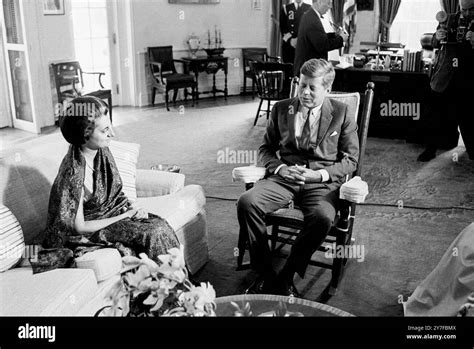 President John F Kennedy seated in his rocking chair with Mrs. Indira ...