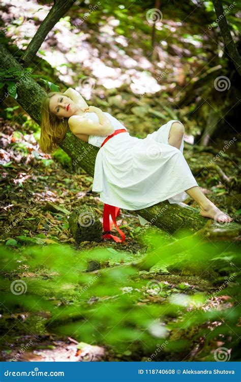 Portrait Of Romantic Blonde Woman In White Dress In Fairy Forest