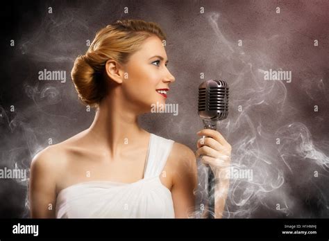 Beautiful Blonde Woman Singer With A Microphone Stock Photo Alamy