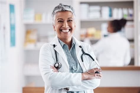 Mature Pharmacist Or Portrait Of Happy Woman With Arms Crossed In Healthcare Clinic Or