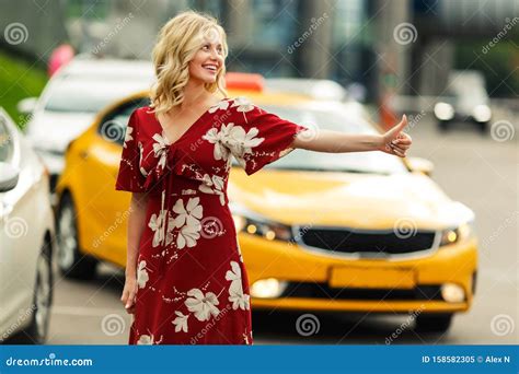 Photo Of Blonde In Red Dress Stopping Taxi On Summer Stock Image Image Of Auto Happy
