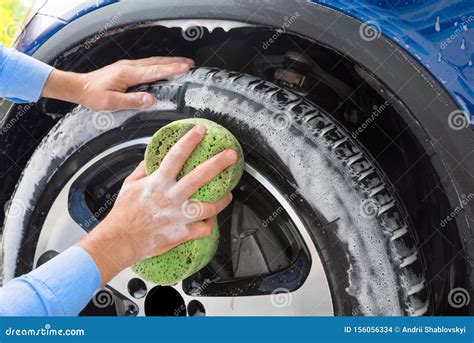 Man, Washing the Wheels of Car on Autowashing. Car Washing Stock Photo ...