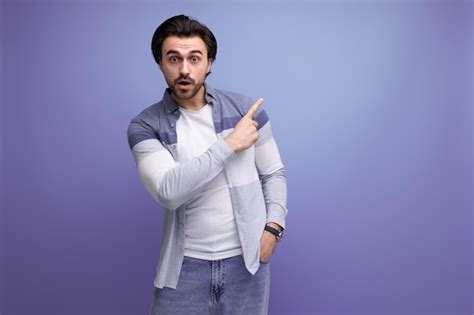 Premium Photo Nice Brunette Guy In Casual Style Shows With His Hand For Having An Idea On A