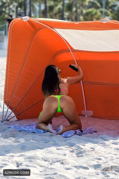 Claudia Romani Sexy In A Neon Lime Black And Pink Thong Bikini While Lounging On South Beach