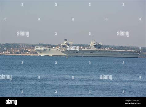 The Royal Navy Aircraft Carrier HMS Queen Elizabeth Dwarfs Ryde On The