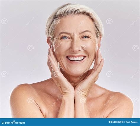 Portrait Of A Happy Smiling Mature Caucasian Woman Looking Positive And Cheerful While Posing