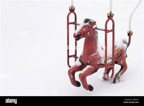Horizontal Top View Of One Red Plastic Child Swing Shaped Like A Horse