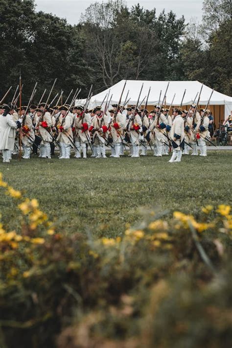 Soldiers with Weapons during Historical Reenactment · Free Stock Photo