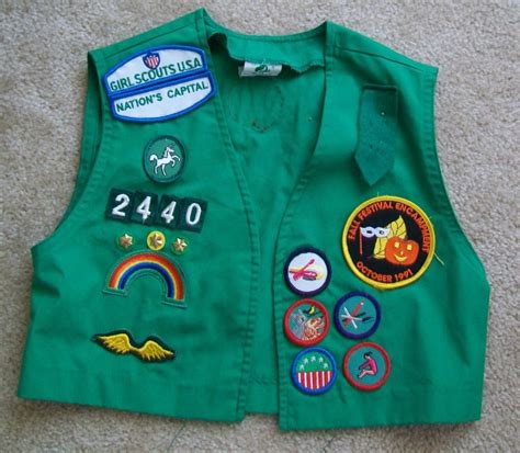 Junior girl scout vest with pins and patches