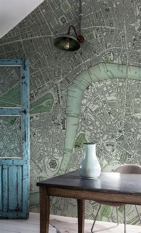 a table with a vase sitting on top of it next to a wallpapered city map