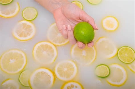 Primer Plano De Una Mano Femenina Sosteniendo Una Lima Sobre Agua