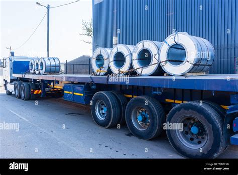 Truck Transporting Heavy Steel Sheet Rolls Secured On Trailer From