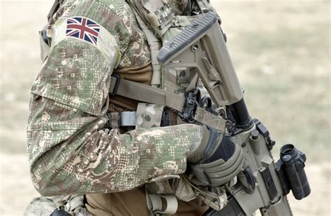 Soldier with Assault Rifle and Flag of United Kingdom on Military ...