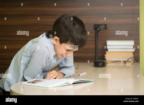 Beautiful Brunette Pupil Elementary School Does Homework Stock Photo Alamy