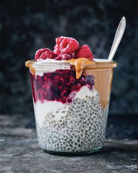 A Jar Filled With Chia Pudding And Topped With Raspberries