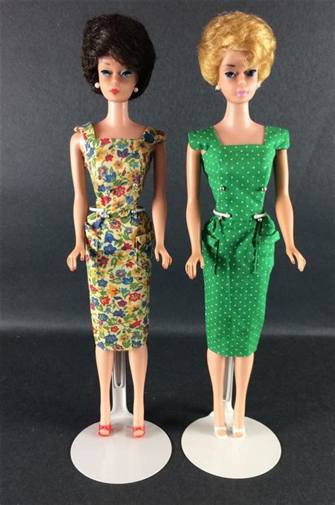 Lot 2 BUBBLE CUT BARBIES INCLUDING BRUNETTE WEARING ON THE GO FLORAL PRINT SHEATH AND