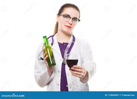 Attractive Caucasian Brunette Female Doctor Standing In Office With Bottle And Glass Of Wine In