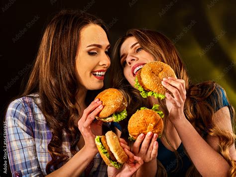 Hamburger Fast Food With Ham And Group People Good Fast Food Concept Friends Two Women Eating