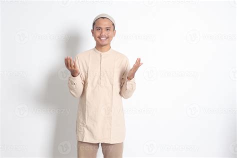 Portrait Of Religious Asian Muslim Man In Koko Shirt With Skullcap