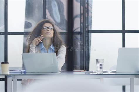 Brunette Trainee In Glasses Sits With A Laptop At A Table In The Office Stock Photo Image Of