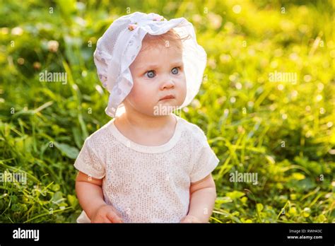 sweet happy  baby girl sitting  grass  park garden meadow