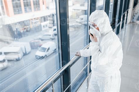 Female doctor scientist in lab coat, defensive eyewear and mask